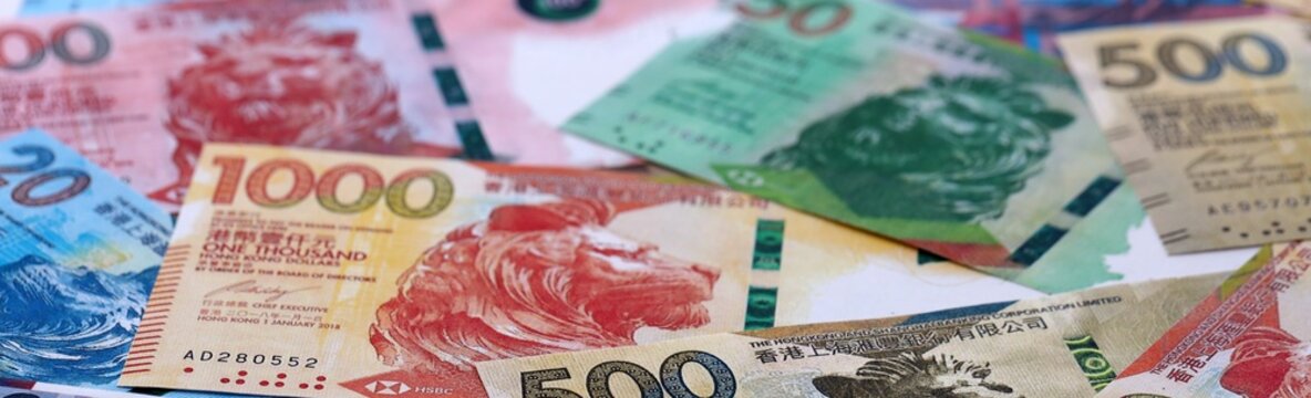 Hong Kong dollar money bills pile on table. Hong Kong banknotes of HKD currency close up.