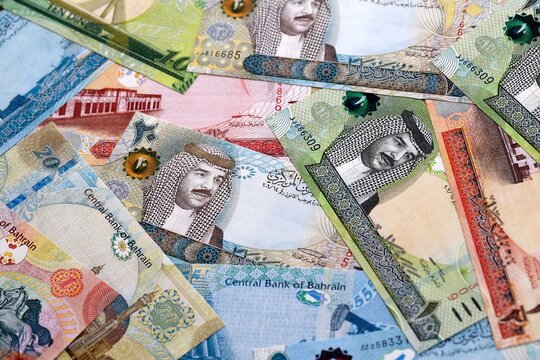 Bahraini dinar money bills pile on table. Bahrain banknotes of BHD currency close up.
