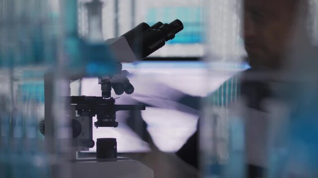 Male scientist or a doctor in protective gloves working in a medical research laboratory. Sorting the samples