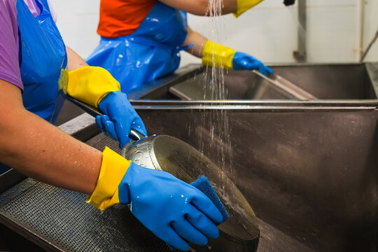 Washing dishes in a commercial kitchen.