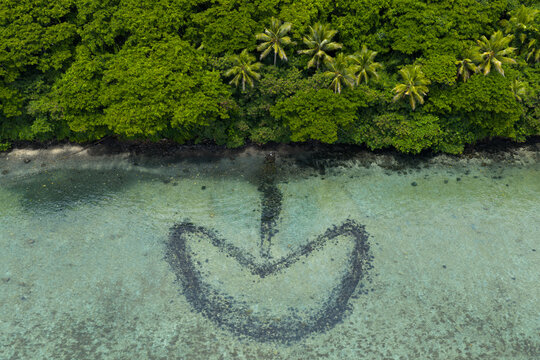An ancient fish trap made of volcanic stones is found on a reef flat at Makogai Island in Fiji. Fish traps such as these have been in place for generations. They trap reef fish as the tide drops.