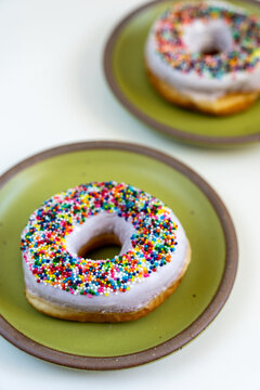 Donut with white icing and colored sprinkles