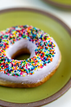 Donut with white icing and colored sprinkles