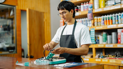 Fototapeta premium Hardware store employee handling rotary tool preparing for repairs