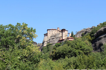Obraz premium Holy Monastery of Rousanou August 2024 Ancient stone building on steep pillar