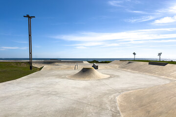 Naklejka premium Modern Concrete Skatepark by the Ocean in Vila Praia de Ancora Portugal