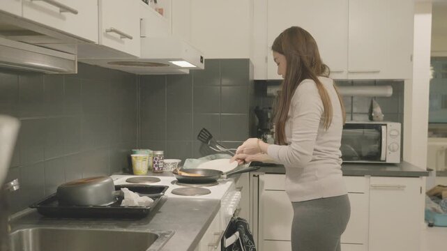 A person prepares a meal in a contemporary kitchen, showcasing the essentials of home cooking and modern appliances.