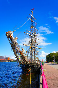 Roald Amundsen brig moored along the waterfront promenade of Ostas Street in the port of Ventspils, Latvia - German two-masted square-rigged training ship in the Baltic Sea