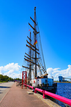 Roald Amundsen brig moored along the waterfront promenade of Ostas Street in the port of Ventspils, Latvia - German two-masted square-rigged training ship in the Baltic Sea