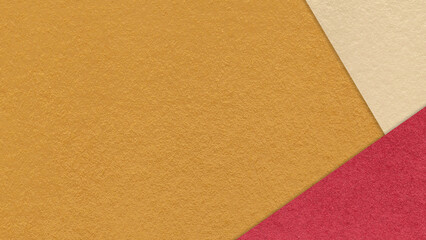 Fototapeta premium Ochre textured paper background with red beige triangular corners and copy space. Template for presentation, banner