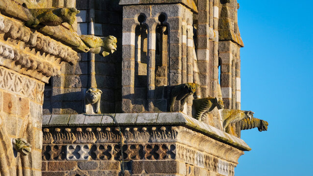 Aerial view of the ancient stone cathedral adorned with grotesque gargoyles under a clear blue sky, Saint-Pol-de-Leon, Brittany, France.