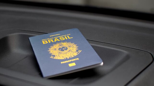 Brazilian passport highlighted on the dashboard, symbolizing travels and adventures. Exploring the world: Brazilian passport featured on the vehicle's dashboard.