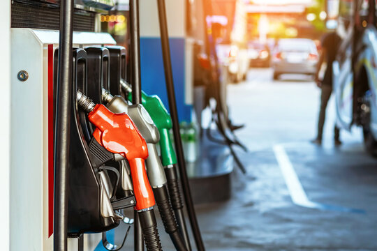 Petrol fuel nozzle for fuelling in petrol fuel station. Hand refilling car with fuel at gas station. Nozzle pump petroleum fuel. Fuel dispensing pump. Fuel and Business service energy concept.