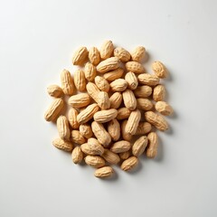 Obraz premium Pile of raw peanuts in shells scattered on white background. Natural legumes are healthy food ingredient for cooking and snacks. Harvested crop ready for processing or consumption.