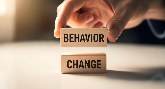 Behavior Change Concept: Hand Holding 'Behavior' Block Above 'Change'
