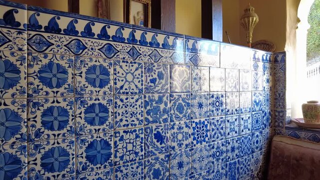 Authentic Craftsmanship Featuring Glazed Cobalt Floral Motifs On Sunlit Ceramic Tile Walls