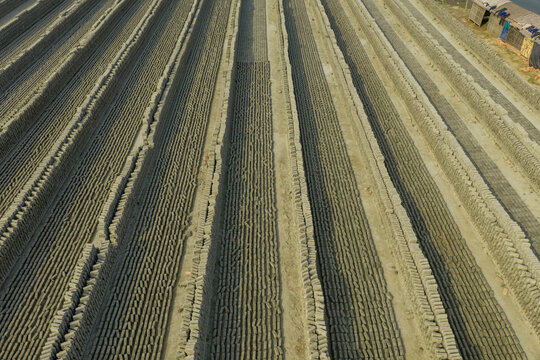 Aerial view of arranged bricks in long lines with pathways in between, Dhaka, Dhaka Division, Bangladesh.