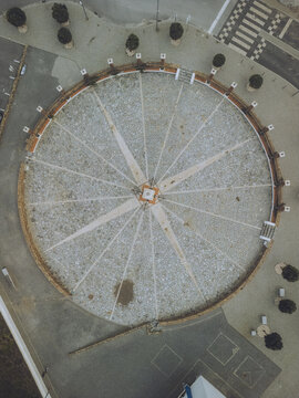 Aerial view of a circular compass rose plaza with radial lines converging at its center, a testament to navigation and exploration, Zambujeira do Mar, Beja District, Portugal.
