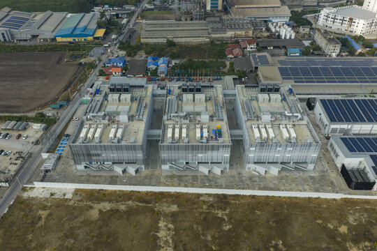 Aerial view of data center complex with multiple server buildings and solar panels, illustrating cloud computing and ai technology in bang sao thong, Thailand