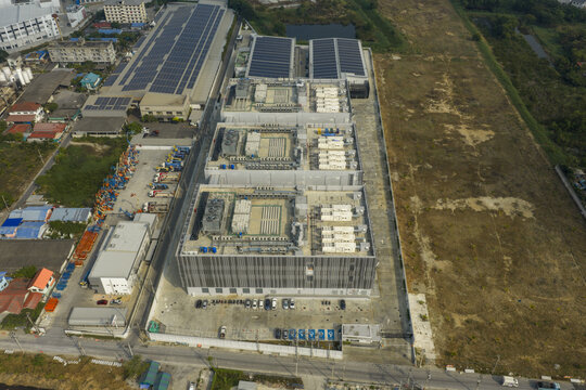 Aerial view of modern data center campus featuring multiple buildings and rooftop solar panels, boosting digital transformation in bang sao thong, Thailand