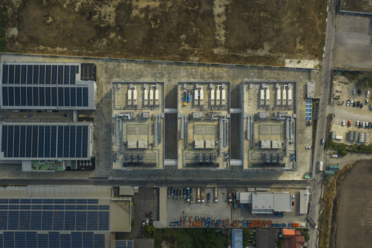Aerial view of global ai data center infrastructure featuring sustainable energy from extensive rooftop solar panels in bang sao thong, thailand