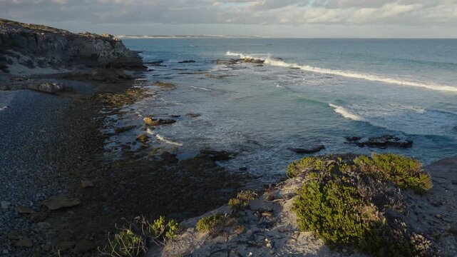 4k 60p footage of stunning turquoise waters along Arniston&rsquo;s beautiful Overberg coastline with sand dunes visible in the background. Western Cape, South Africa. Iconic, remote coastal serenity.