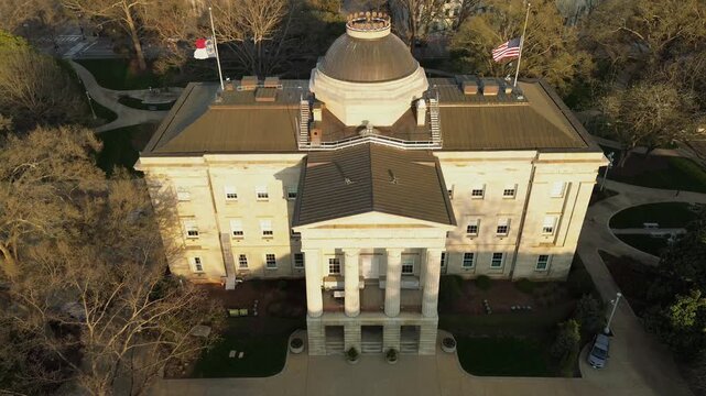 Aerial view of the North Carolina State Capitol building in downtown Raleigh with the American and state flag flying