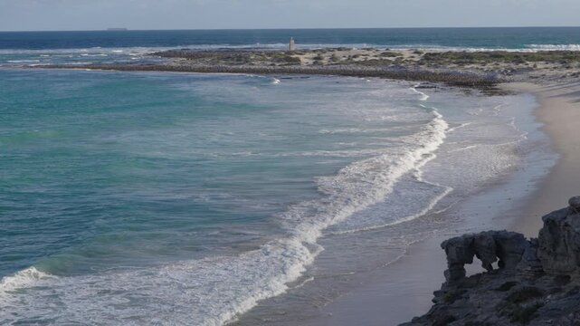 4k 60p footage of dramatic coastal view to Struis Point (Struispunt) and Saxon Reef from rugged sea cliffs near Waenhuiskrans Cave, Arniston. Turquoise Overberg waters, Western Cape, South Africa.