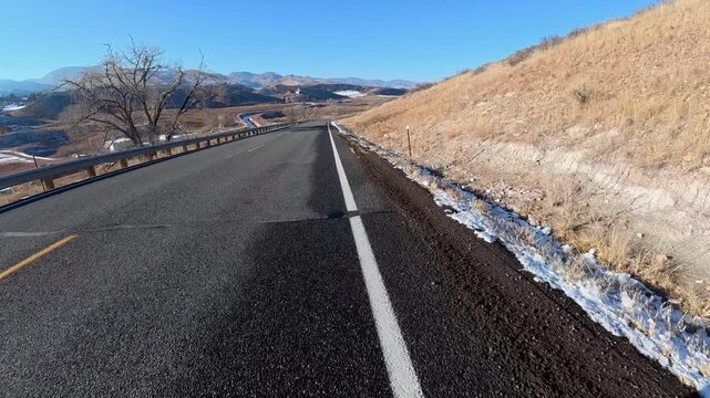 Immersive POV from winter biking on the Centennial Road along Horsetooth Reservoir in Colorado foothills near Fort Collins
