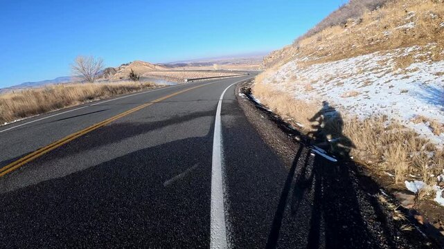 Immersive POV from winter biking on the Centennial Road along Horsetooth Reservoir in Colorado foothills near Fort Collins
