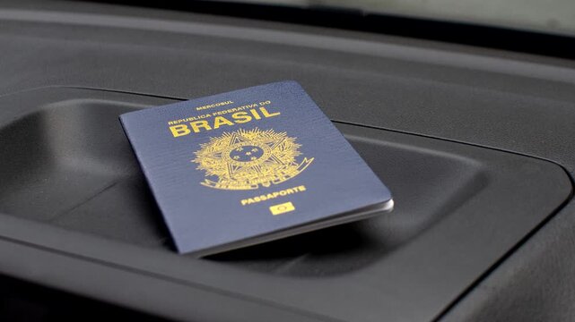 Brazilian passport highlighted on the dashboard, symbolizing travels and adventures. Exploring the world: Brazilian passport featured on the vehicle's dashboard.