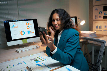 Professional woman analyzing financial data on smartphone