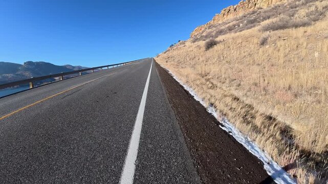 Immersive POV from winter biking on the Centennial Road along Horsetooth Reservoir in Colorado foothills near Fort Collins