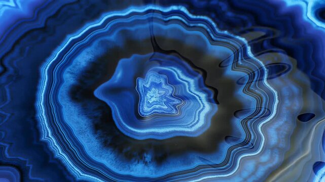 Vibrant blue agate stone cross-section reveals intricate layered patterns