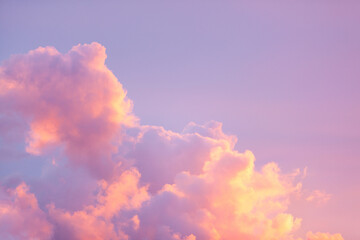 Beautiful fluffy cumulus clouds in a vibrant sunset sky with soft pastel shades of pink, purple, and orange. Dreamy cotton candy clouds at golden hour, perfect for peaceful nature backgrounds. © Francis