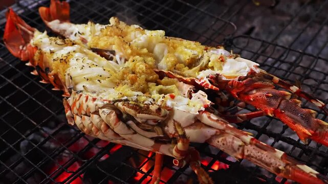 Grilled spiny lobster cooking closeup, seafood barbecue. Asian street cuisine concept with fresh shellfish roasted over charcoal fire at Vietnam night market food stall.