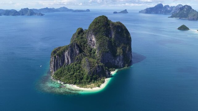 Cinematic aerial video of tropical island in the Philippines with lime stone rock, palm trees and beautiful beach