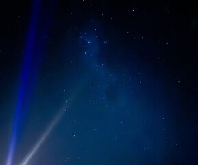 Fototapeta premium A beautiful image of the night sky with rays of light and stars. Space for creative text and advertising. Copy space 