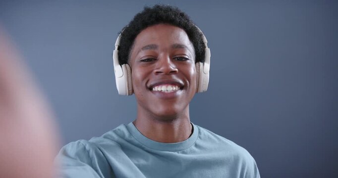 Man pressing phone record, mouthing song, gesturing, animated waveform tracing headphones for music