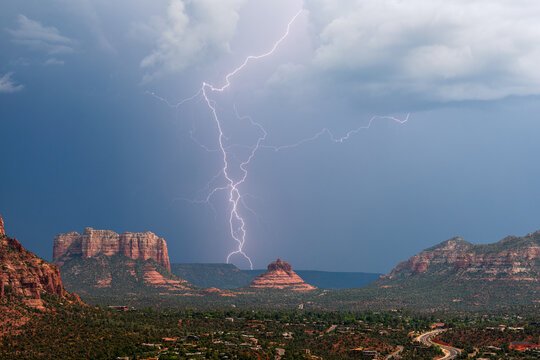 Lightning strike behind Bell Rock in Sedona, Arizona