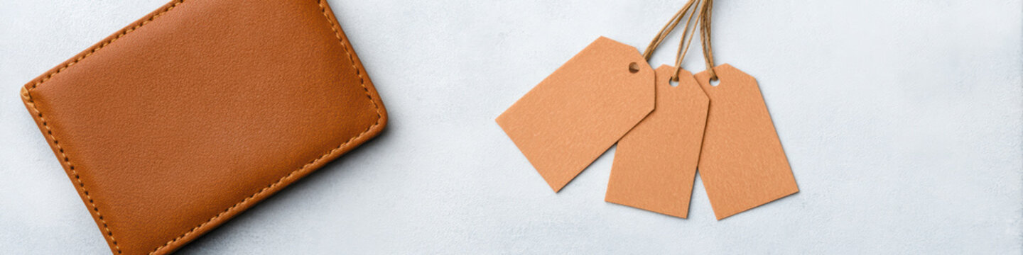 Brown leather wallet with three blank price tags on light background minimal styles close up of minimalist composition featuring ce b eae