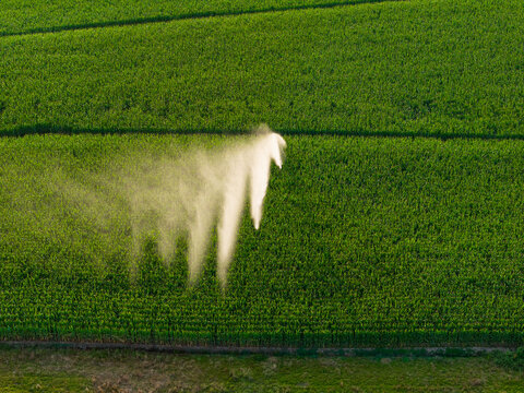 Irrigation of a field in front of a sunset. Agriculture in a hot summer in France