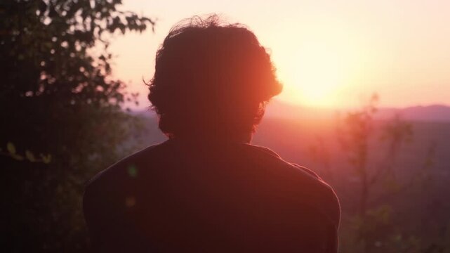Man in Silhouette Contemplating Nature at Golden Hour Sunset