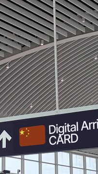 Modern airport overhead sign directing passengers to China Digital Arrival Card or CDAC processing and Smart Lane featuring active facial recognition for automated border control and immigration.