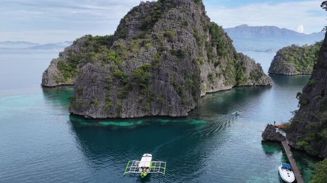 Cinematic aerial video of tropical islands of Coron in the Philippines with limestone cliffs and azure blue water lagoons