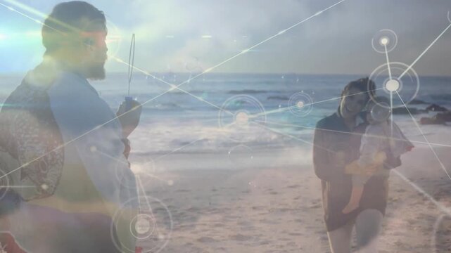 Network graphic appearing, parents holding rod and cradling baby, connecting family via tech