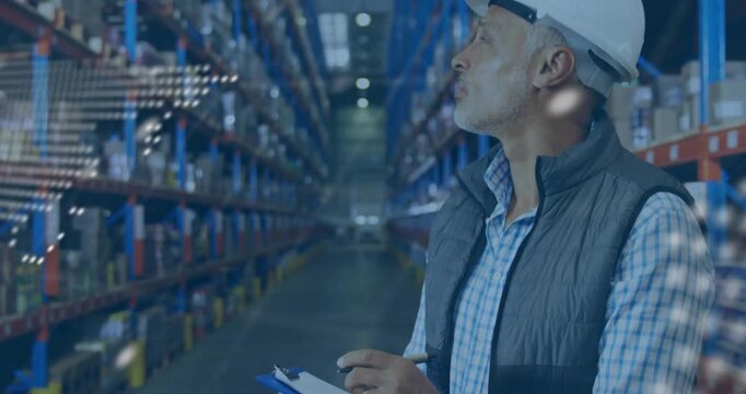 Vertical video: Checking tablet with pen, man in vest  and  helmet scanning warehouse racks, copy sp