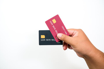 Hand holds two credit cards against a clean white background