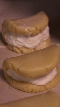 A girl cooks pies with cottage cheese . Vertical video about homemade pastries, cooking and confectionery