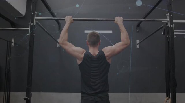 Man gripping pullup bar in gym and doing pull-ups, engaging lats as light overlays appearing